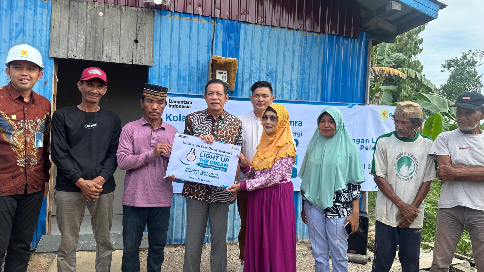 Dokumentasi bersama usai pemasangan meteran listrik yang diberikan kepada warga di Sambaliung.