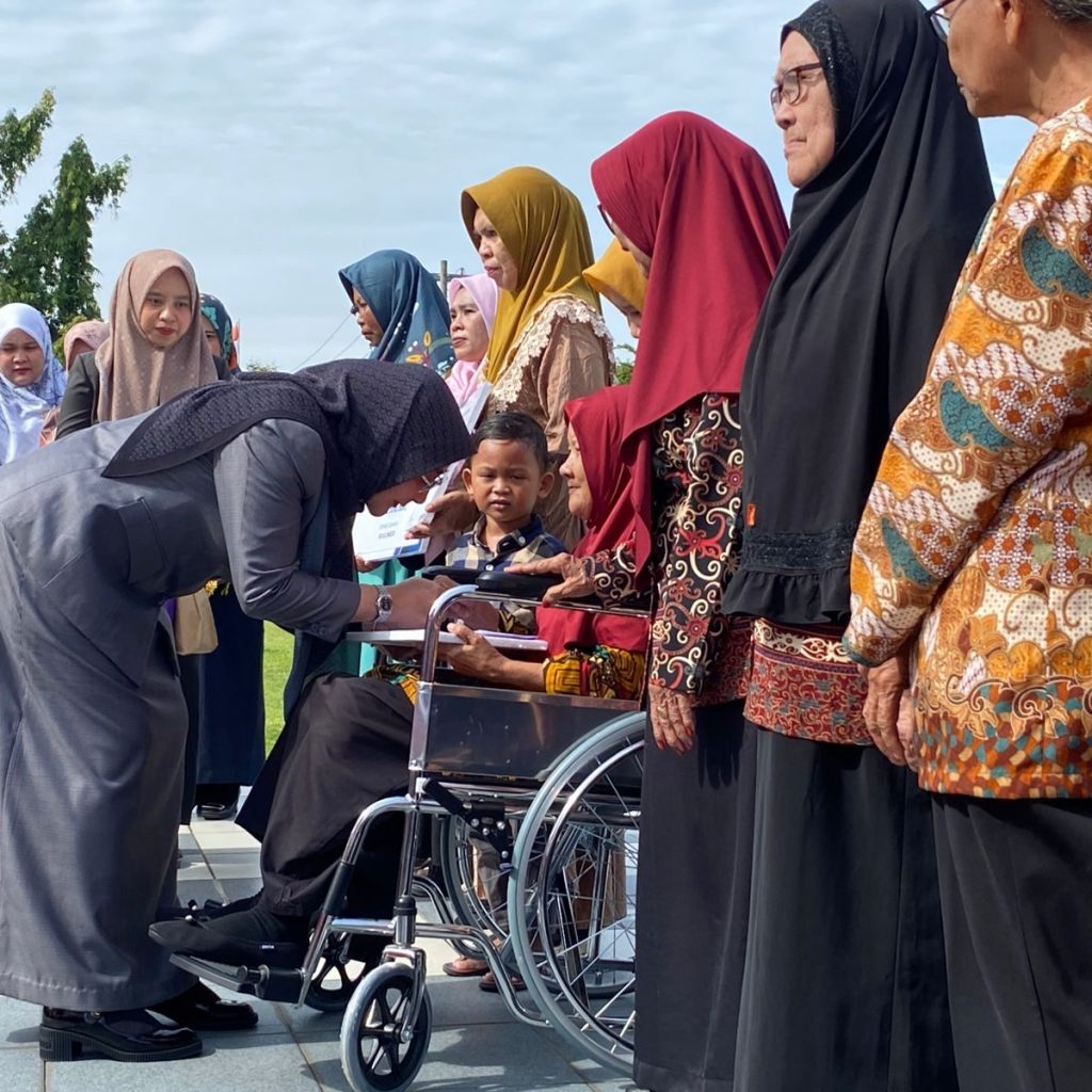 Bupati Berau, Sri Juniarsih, memberikan santunan bagi istri veteran saat upacara Hari Pahlawan di Halaman Kantor Bupati, Senin (10/11/2025). (Sulaiman/BT)