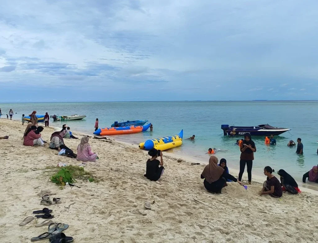 Wisatawan yang tengah bermain di pantai Pulau Derawan Berau.